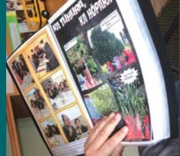 A close-up of a te reo Māori book with photos of people outdoors