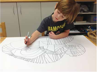 Boy drawing a design